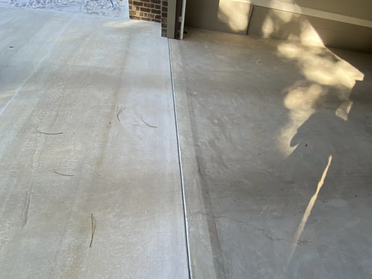 Bare concrete garage entry before coating